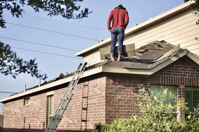 Professional roofer working on a residential roof in Fairway Hills
